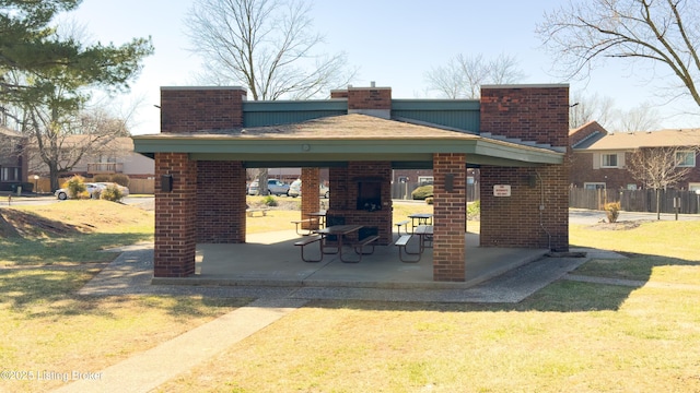 view of property's community with a gazebo, a lawn, and a patio