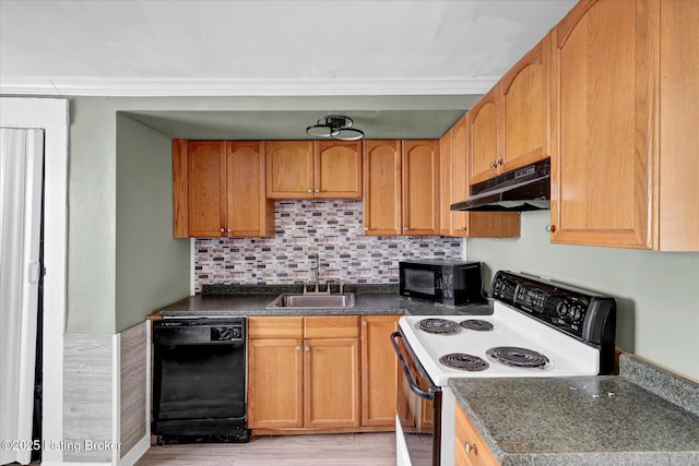 kitchen featuring dark countertops, decorative backsplash, a sink, under cabinet range hood, and black appliances