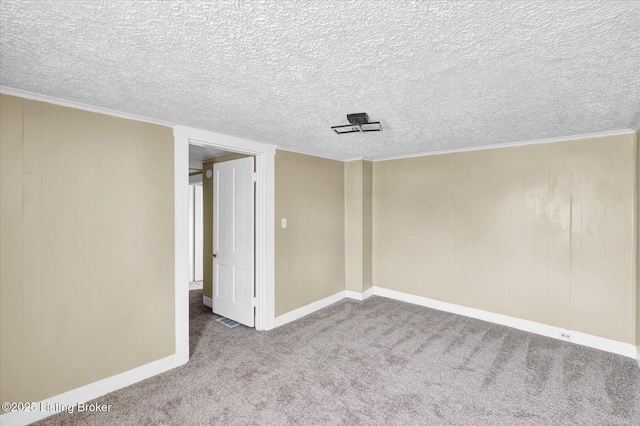 carpeted empty room with baseboards and a textured ceiling