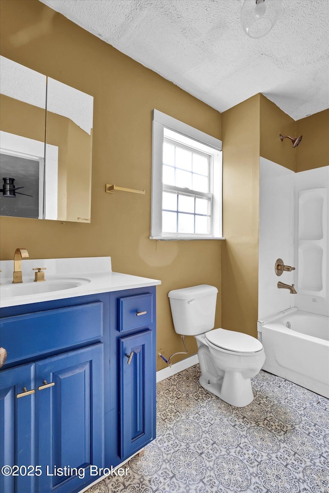 full bath featuring a textured ceiling, toilet, vanity,  shower combination, and tile patterned floors