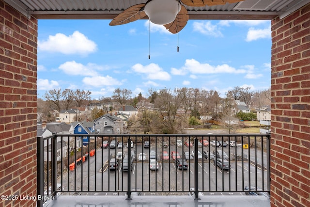 balcony featuring a residential view and a ceiling fan