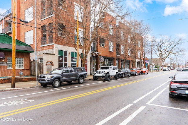 view of street with curbs, sidewalks, and street lights