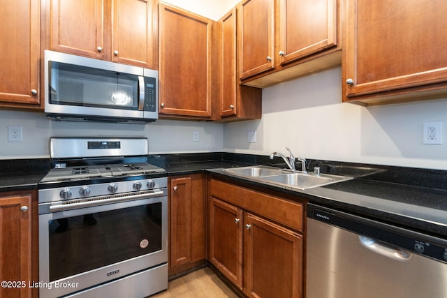 kitchen with stainless steel appliances, brown cabinetry, and a sink