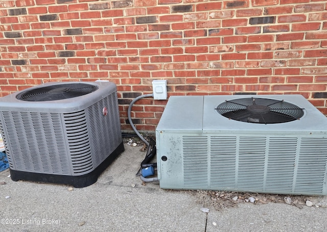 exterior details with brick siding and central AC