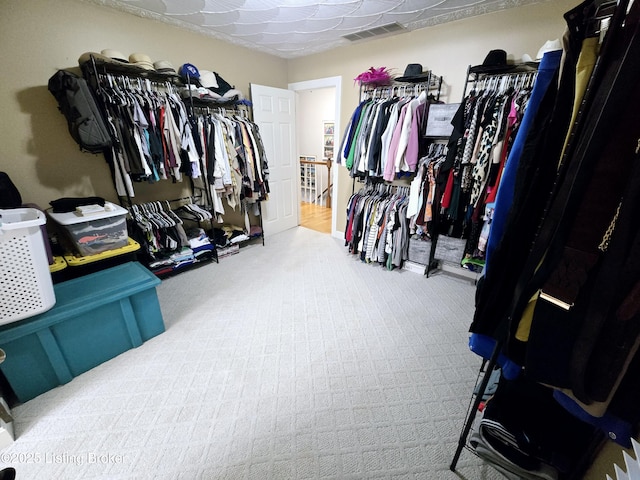 walk in closet with visible vents and carpet flooring