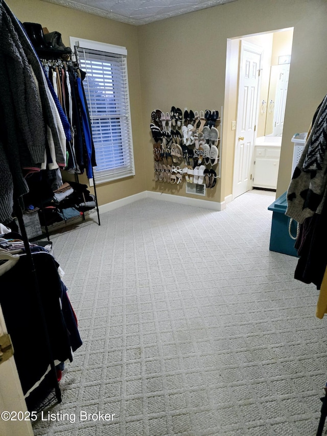 spacious closet with carpet flooring