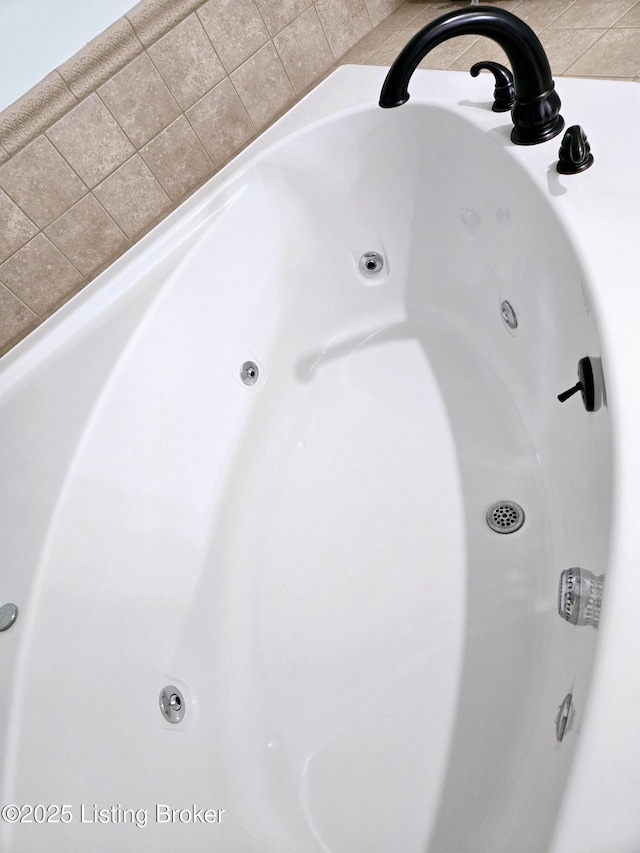 interior details featuring a tub with jets