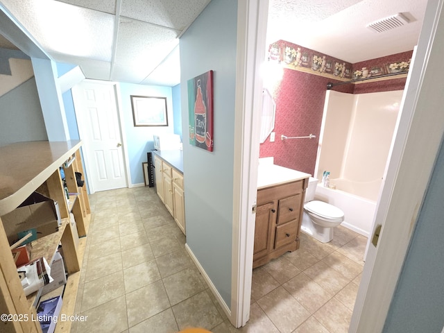 bathroom with toilet, visible vents,  shower combination, and vanity