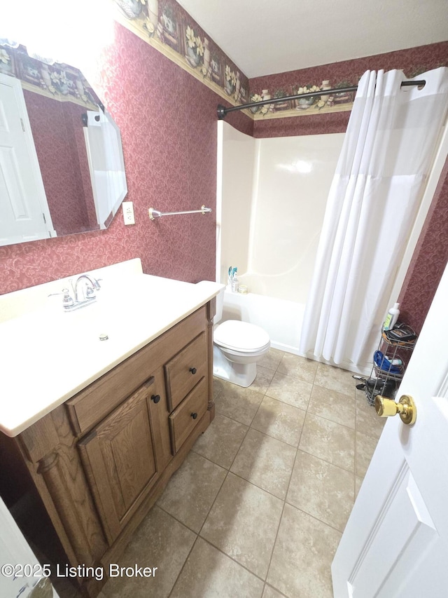 bathroom featuring shower / bathtub combination with curtain, toilet, vanity, tile patterned flooring, and wallpapered walls