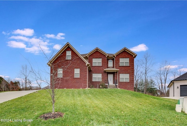 traditional home with a front lawn and brick siding