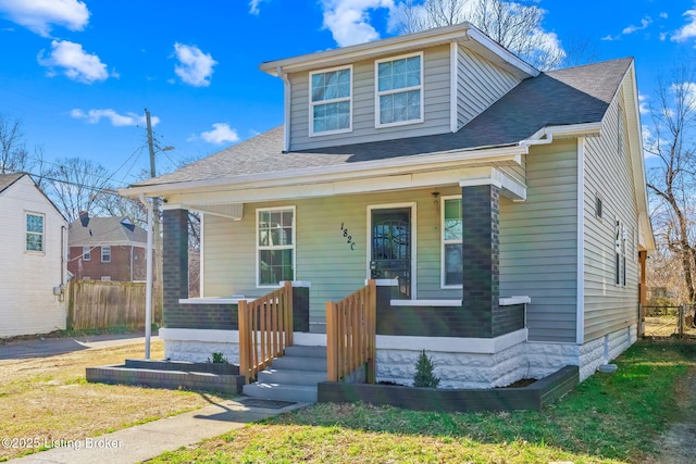 bungalow-style house featuring a porch and fence