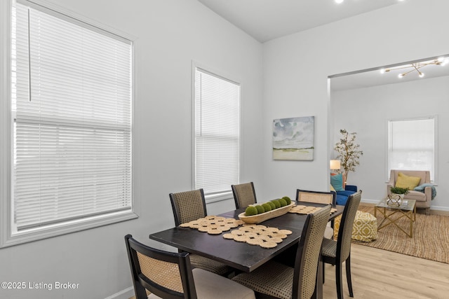 dining room with light wood-style floors and baseboards