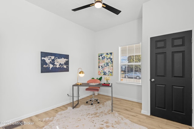 home office with a ceiling fan, wood finished floors, and baseboards