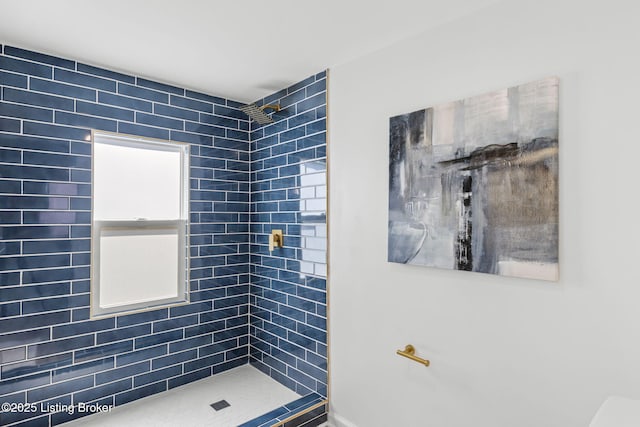 bathroom with a tile shower