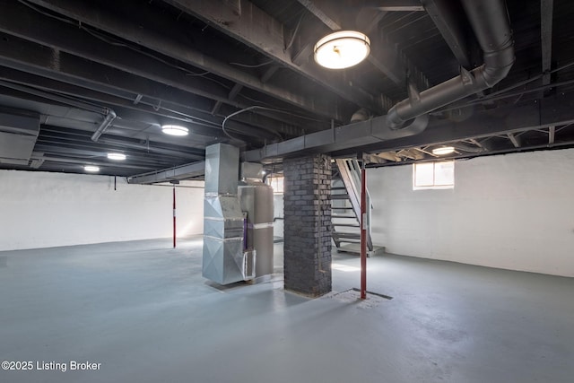 basement with heating unit and stairs