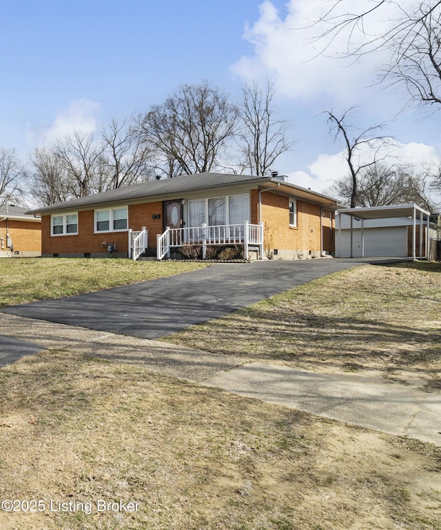 view of front of home featuring an outbuilding, brick siding, covered porch, crawl space, and a garage