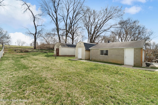 view of yard with a storage unit and an outbuilding