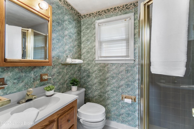 full bathroom with toilet, wallpapered walls, a shower stall, and vanity