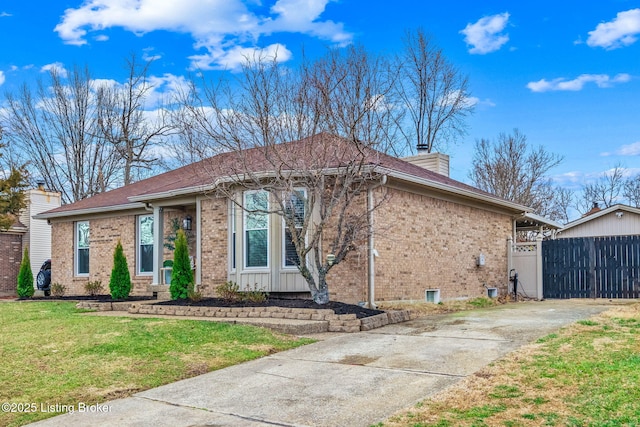 ranch-style home with a chimney, fence, a front lawn, and brick siding