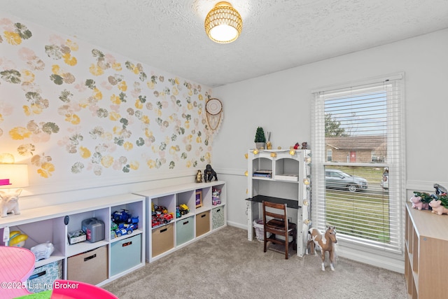 game room with carpet flooring, a textured ceiling, and wallpapered walls