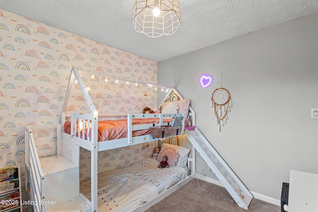 carpeted bedroom with a textured ceiling and baseboards