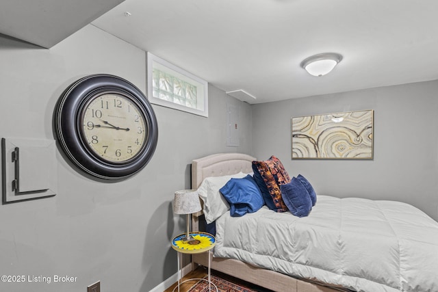 bedroom featuring baseboards and wood finished floors