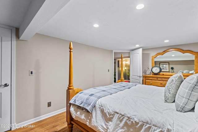 bedroom with recessed lighting, baseboards, and wood finished floors