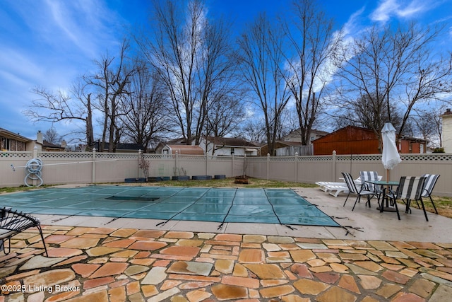 view of swimming pool featuring a fenced in pool, a patio, and fence