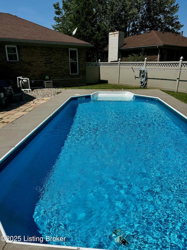 view of swimming pool with fence and a fenced in pool