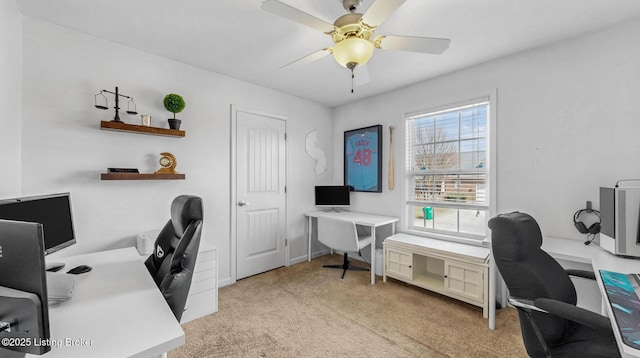 home office featuring light colored carpet and ceiling fan