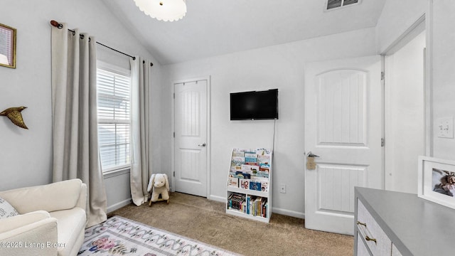 sitting room featuring light colored carpet, lofted ceiling, visible vents, and baseboards