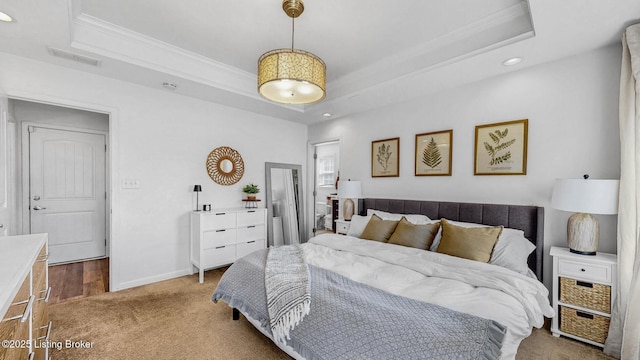 bedroom with visible vents, a tray ceiling, and crown molding