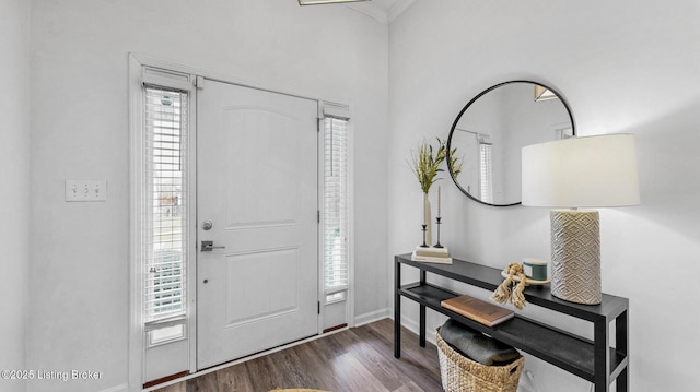 foyer with baseboards and dark wood finished floors