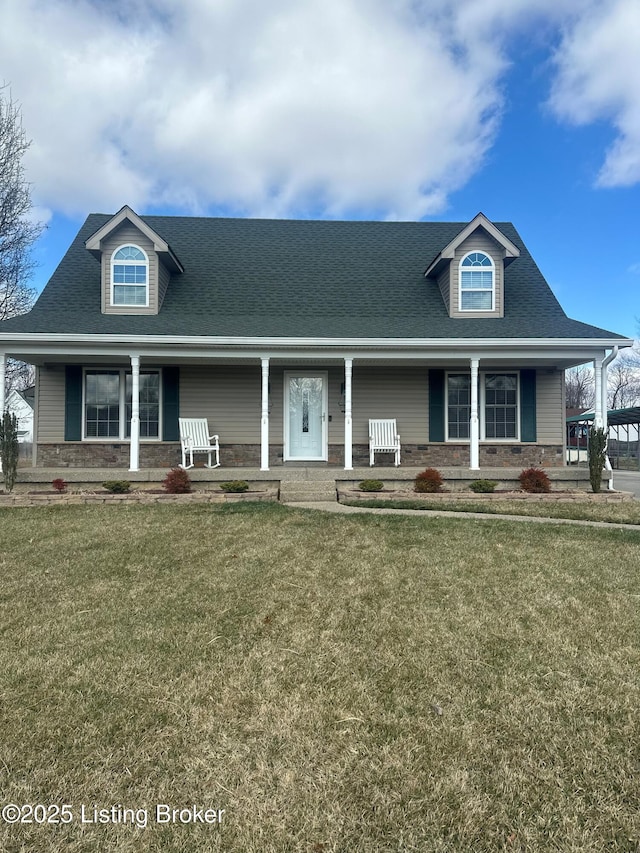 view of front facade featuring covered porch, a front yard, and roof with shingles