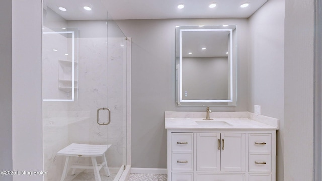 bathroom with recessed lighting, baseboards, a stall shower, and vanity