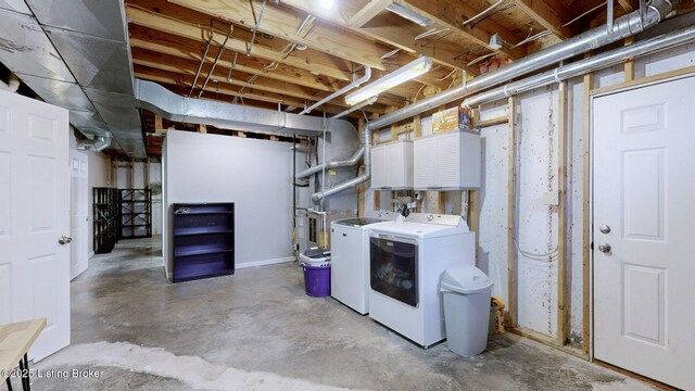 unfinished basement with washing machine and clothes dryer