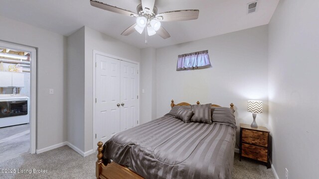 bedroom featuring a ceiling fan, visible vents, baseboards, a closet, and light colored carpet