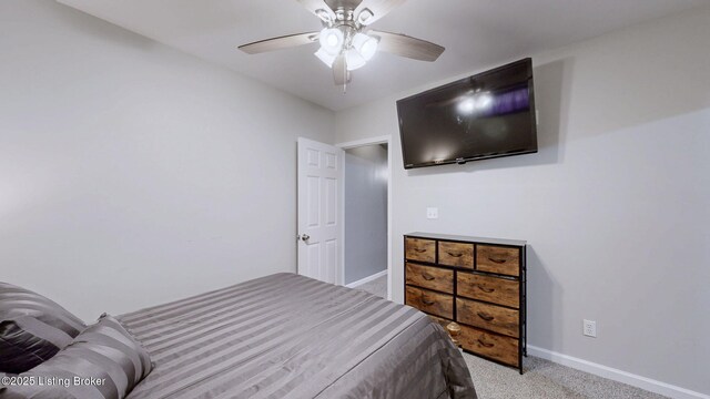 carpeted bedroom featuring a ceiling fan and baseboards