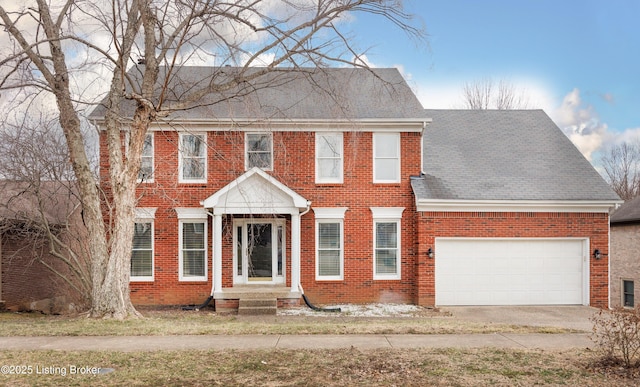 view of front facade with brick siding and an attached garage