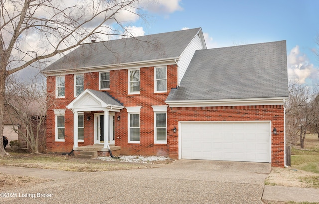 view of front of home featuring a garage, brick siding, driveway, and a shingled roof