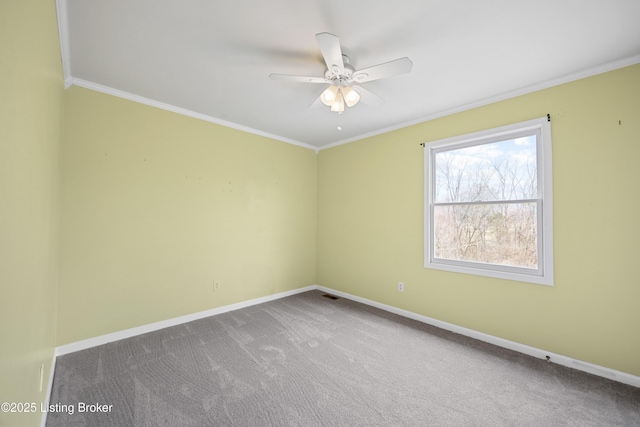 carpeted spare room with visible vents, baseboards, and crown molding