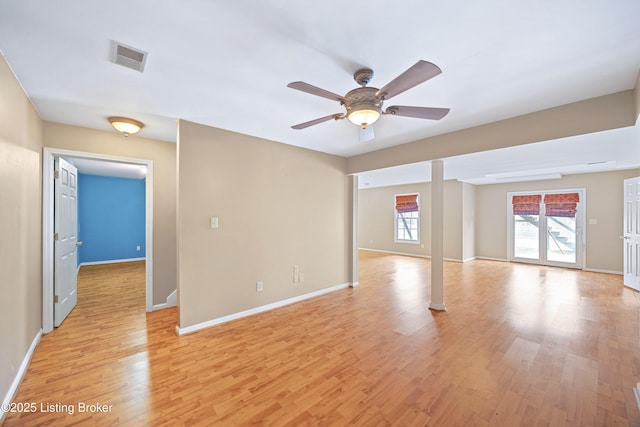 unfurnished room featuring ceiling fan, light wood finished floors, visible vents, and baseboards