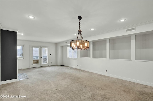 empty room featuring light carpet, baseboards, visible vents, and crown molding