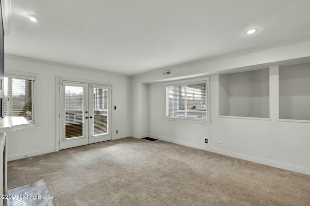 carpeted spare room with french doors, recessed lighting, visible vents, ornamental molding, and baseboards