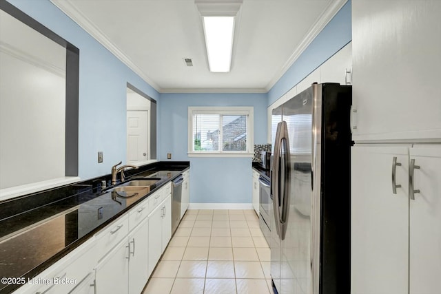 kitchen featuring stainless steel appliances, ornamental molding, a sink, and white cabinets