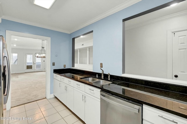 kitchen with white cabinets, ornamental molding, stainless steel appliances, and a sink