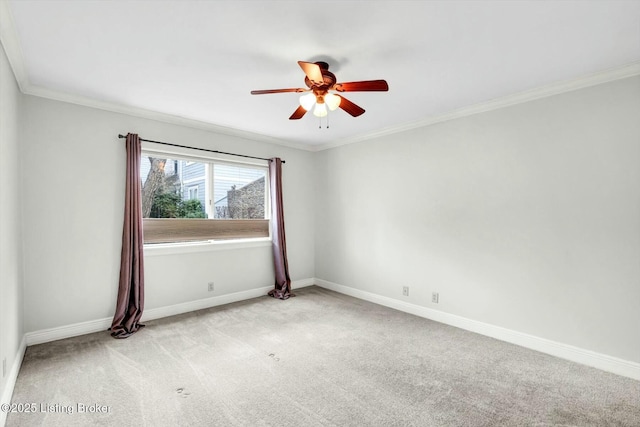 empty room featuring carpet, baseboards, ceiling fan, and ornamental molding