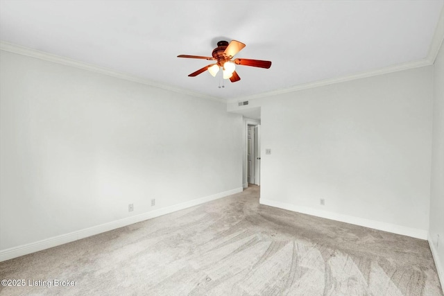 carpeted empty room featuring baseboards, visible vents, ornamental molding, and ceiling fan