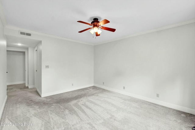 unfurnished room featuring baseboards, ornamental molding, visible vents, and light colored carpet