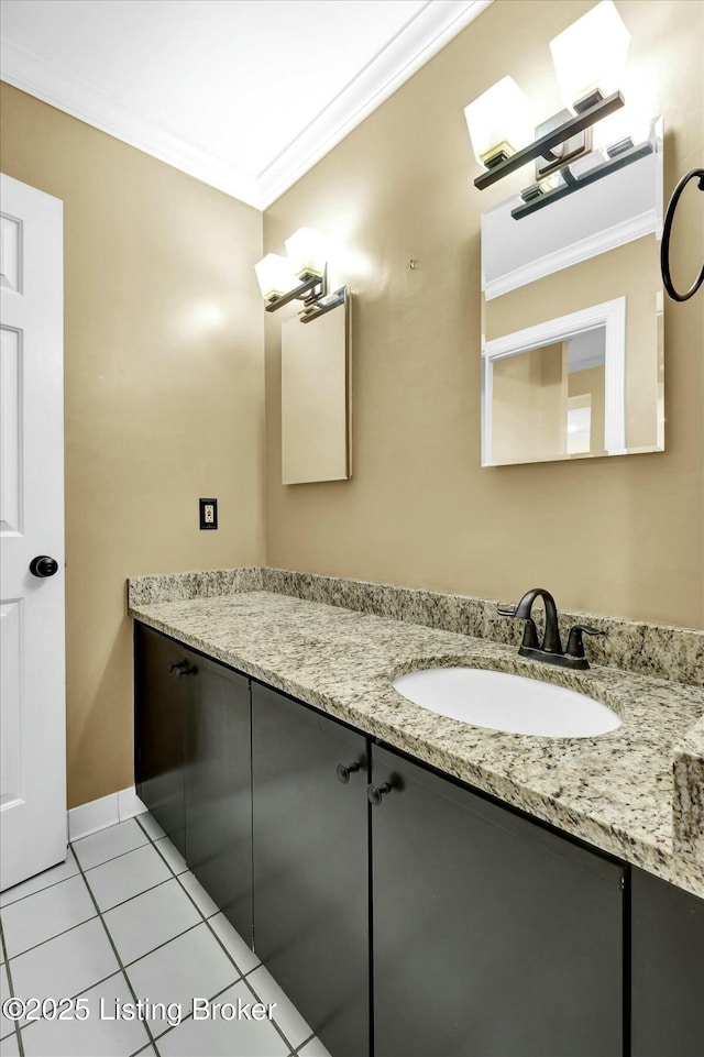 bathroom featuring vanity, baseboards, crown molding, and tile patterned floors